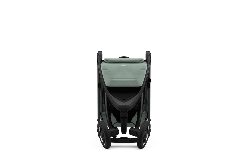 Lightweight Thule Spring 2 single child stroller with ventilated canopy and adjustable handlebar, shown in a compact fold.
